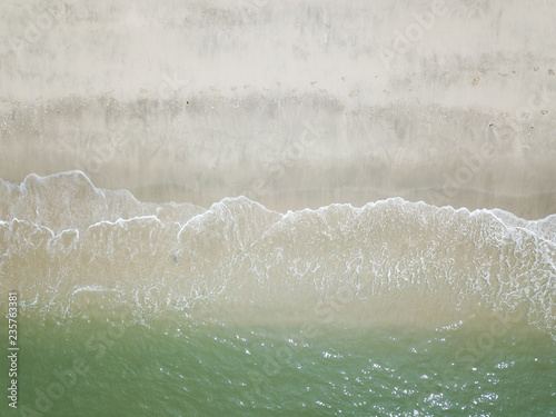 Aerial view of waves on the sandy beach