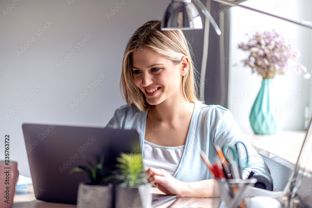 Beautiful young woman working at home office Beautiful young woman working at home office