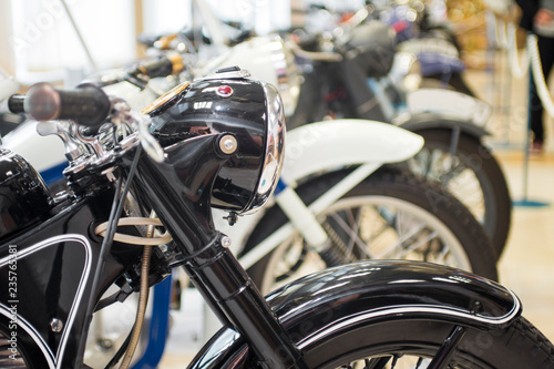 Row of many motorcycle for sale. Motorcycles standing in the row at a store, closeup. Motobikes in a row © spyrakot