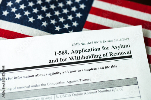 Application for asylum to USA concept with application form and USA flag