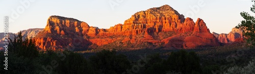 A panorama image of the red rocks of Sedona, Arizona during the golden hour at sunset.