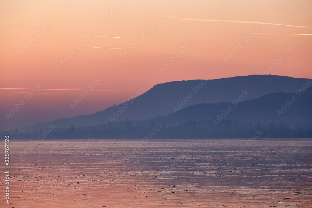 Sunset light over the frozen lake Balaton in Hungary