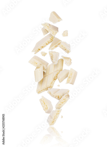 Obraz na plátně Broken porous white chocolate fall down on white background