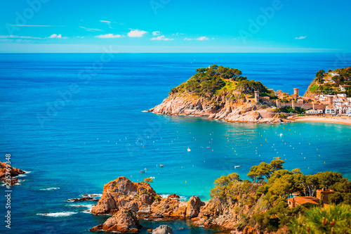 Spanish mediterranean coast at the Costa Brava with village Tossa de Mar and his medieval. Teal and orange mood. photo