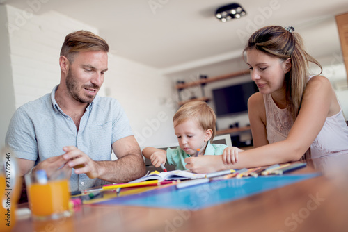 Parents draw with a little son