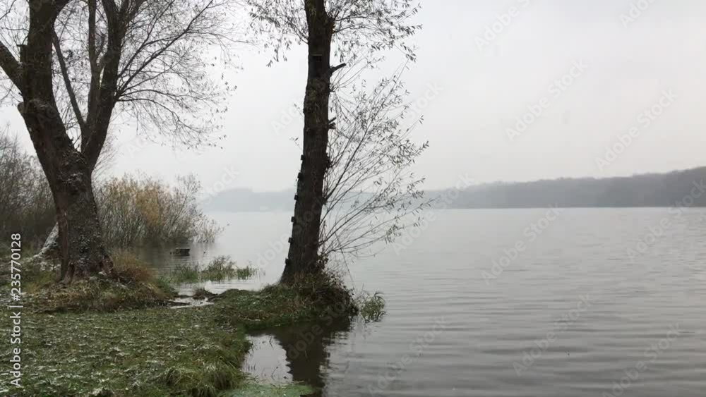 Waves on a lake surface during cold autumn when snowing Waves on a lake surface during cold autumn when snowing