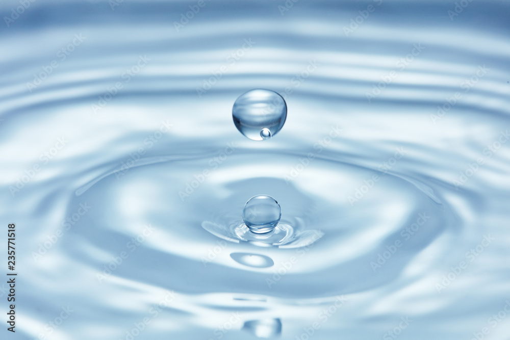 pure blue water surface with droplet splash