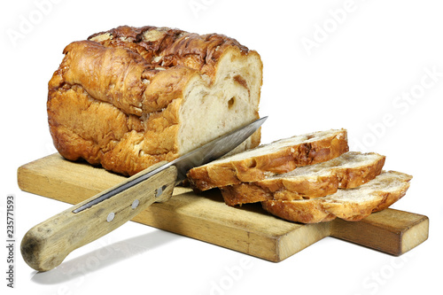 Frisian Suikerbrood (sugarbread) with knife and wooden plate isolated on white background photo