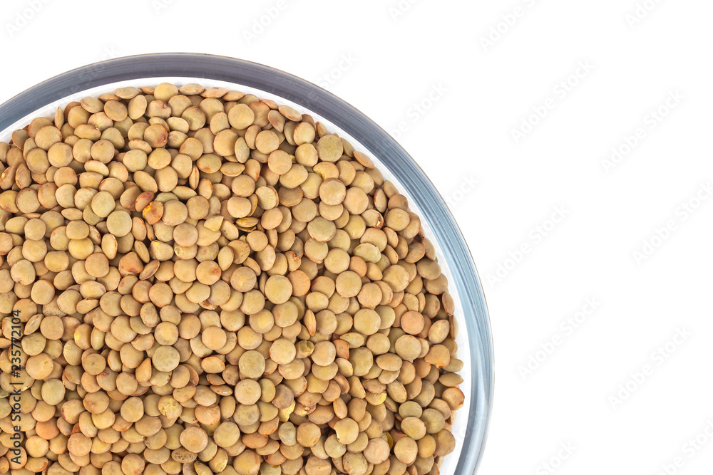 Dry lentil in glass bowl isolated on white background Dry lentil in glass bowl isolated on white background