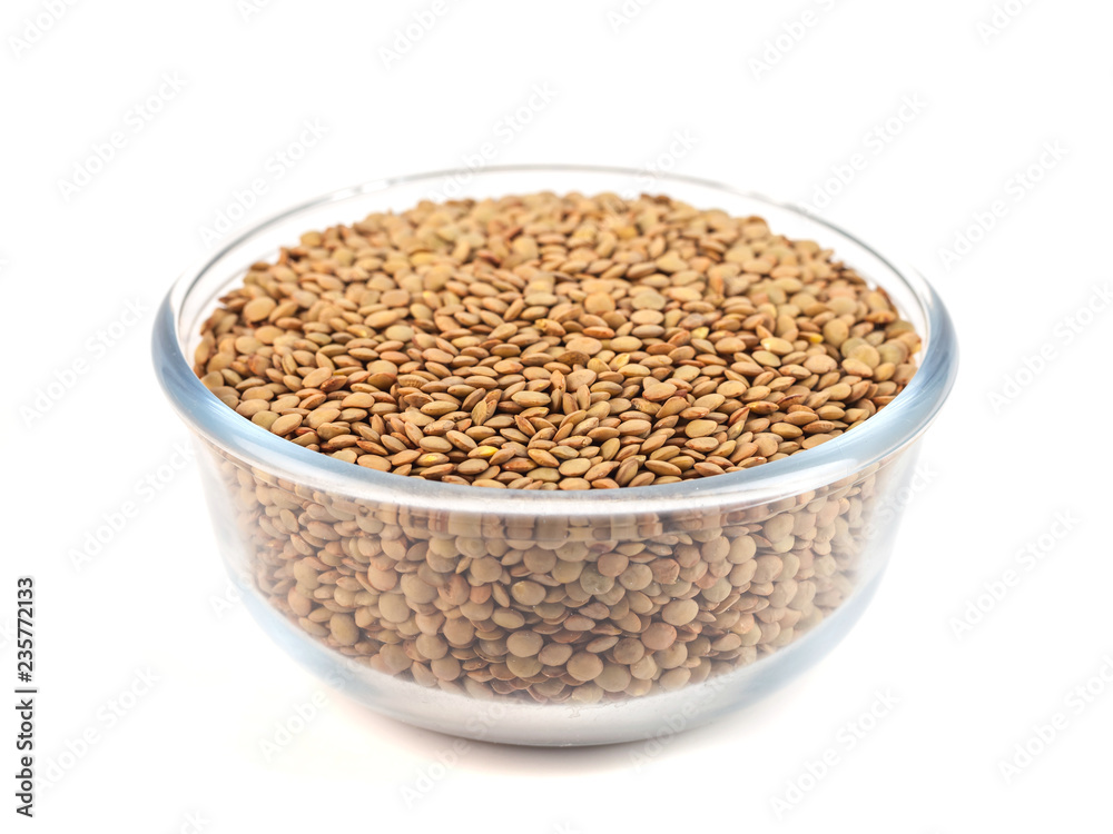 Dry lentil in glass bowl isolated on white background Dry lentil in glass bowl isolated on white background