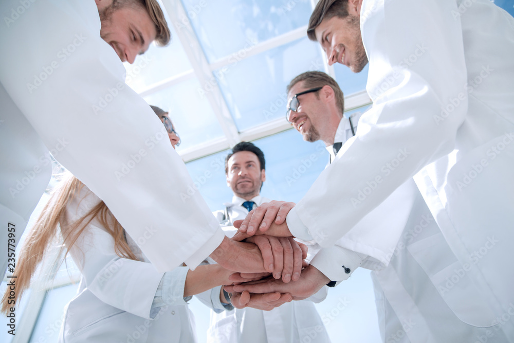 Obraz premium bottom view. close up of a doctors folded their hands together