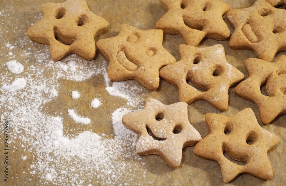 Smile face gingerbread cookies in star shape, Christmas aromatic and spiced cookies