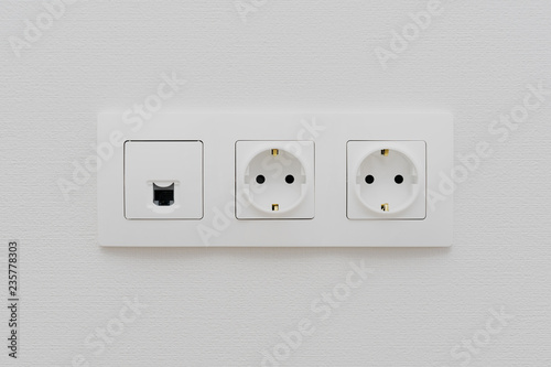 a socket on a light wall, a multifunction outlet with an internet connection, two European-style outlets
