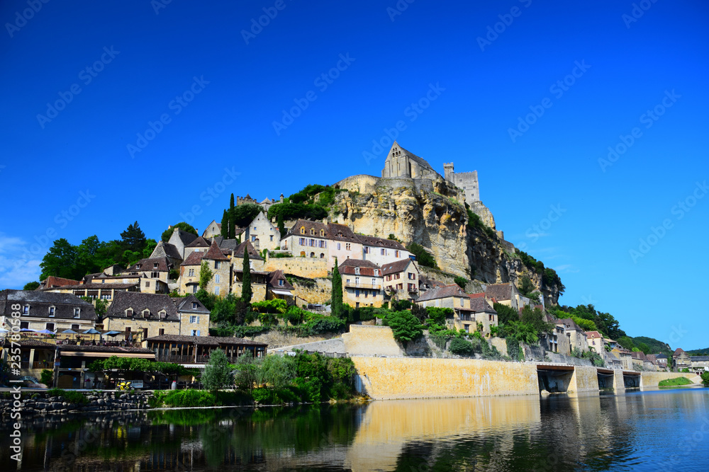 The medieval fortress and village of Beynac as seen from the Dordogne River in Aquitaine, France