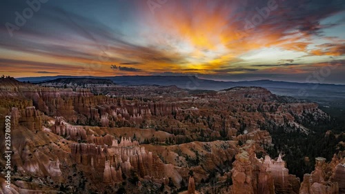 4k Timelapse movie film clip of Bryce Canyon sunrise sunset with clouds and pink sky during twilight with shadows moving across the landscape of bryce canyon in utah in summer with snow on the ground