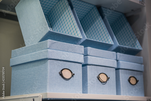 Fancy blue textile gift storage box on a shelf