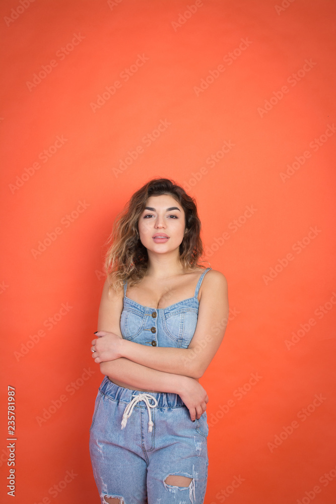 portrait of sexy beautiful girl with curly hair in jeans clothes portrait of sexy beautiful girl with curly hair in jeans clothes