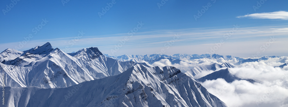 Panorama of snowy mountains in clouds