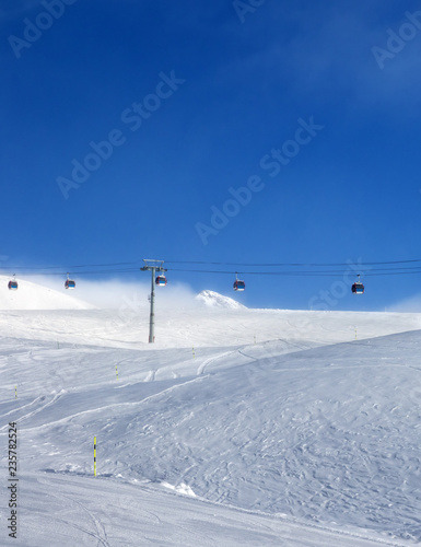 Gondola lift and off-piste ski slope in fog