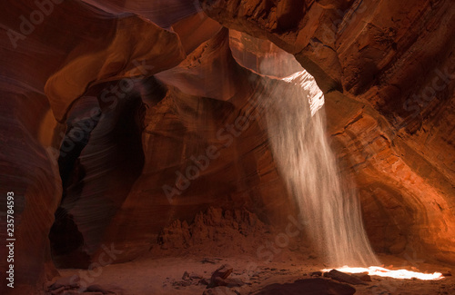 Sand streams down into the Grotto in Cardiac Canyon, Navajo reservation, Arizona