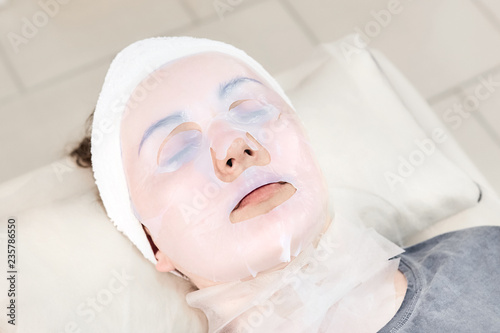 Bioсellulose Fiber Lifting Mask. Facial treatment. Cosmetic skincare procedure. Woman in a beauty salon