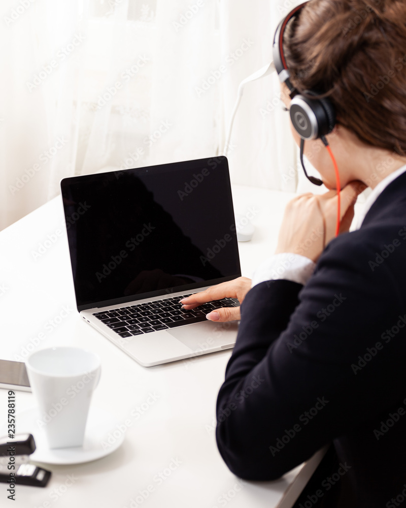 over the shoulder shot of young business woman with headset e-learning call-center support software over the shoulder shot of young business woman with headset e-learning call-center support software