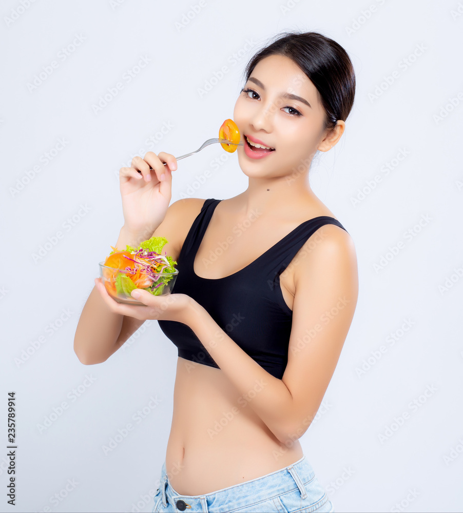 Beautiful portrait young asian woman smiling holding salad vegetable food isolated on white background, girl diet eating vegetarian for healthy, health care or wellness concept. Beautiful portrait young asian woman smiling holding salad vegetable food isolated on white background, girl diet eating vegetarian for healthy, health care or wellness concept.