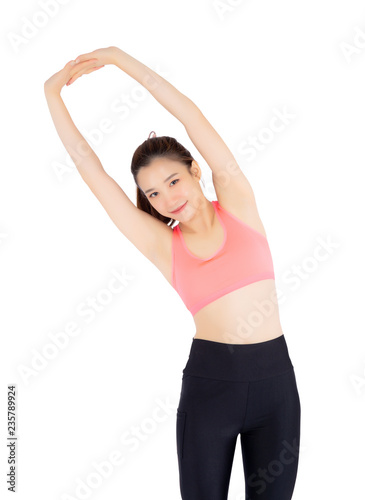 Beautiful portrait young asian woman standing stretch muscle arm isolated on white background, girl wear sport clothes exercise and yoga for health, wellness concept. © N_studio