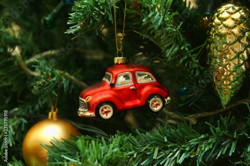 Red car toy, cone and ball on Christmas tree photo