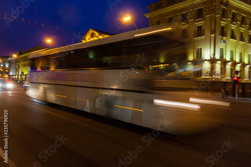 The motion of a blurred bus on the avenue in the evening. © leon134865