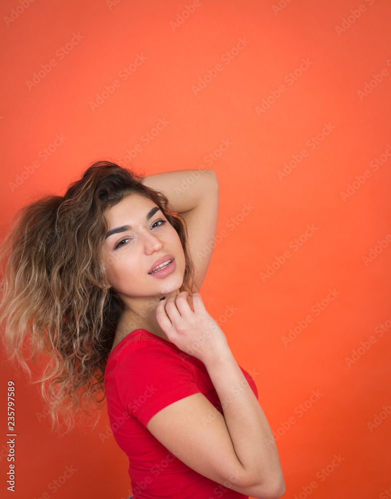 positive girl on a red background in a red t-shirt positive girl on a red background in a red t-shirt