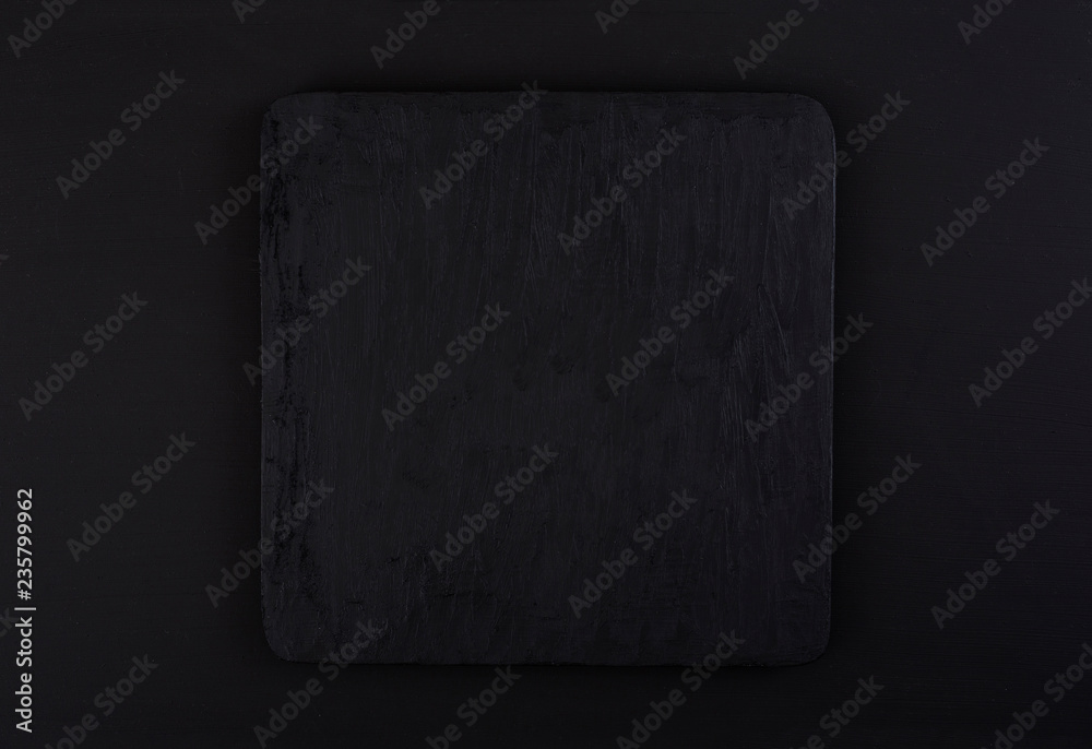 Naklejka premium textured black marble platform on black background