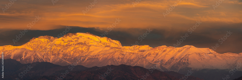 Naklejka premium Cerro El Plomo summit at Central Andes mountain range covered with snow an amazing alpine view from the valleys to the summits such an incredible rough landscape could be found at Santiago de Chile