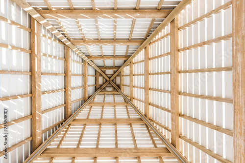 Looking up abstract low angle of wooden pavilion tower roof ceiling closeup by beach ocean gazebo in Florida, architecture, view photo