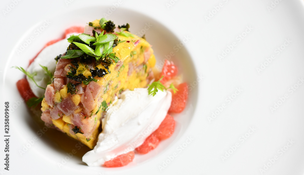 Seafood tuna tartar salad on white plate Seafood tuna tartar salad on white plate