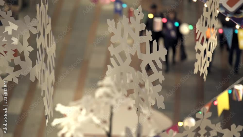 Christmas and New Year's decoration of a mall with white paper snowflakes Christmas and New Year's decoration of a mall with white paper snowflakes