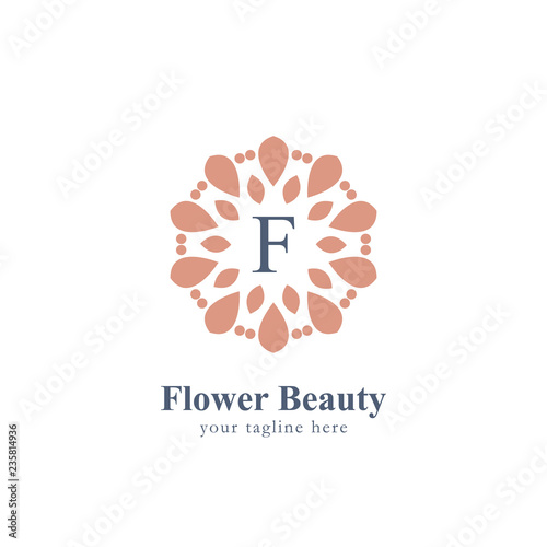 Abstract flower beauty logo with letter F in the center flower symbol