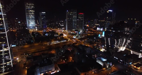 Flying over Tel Aviv City and traffic at Night  Drone shot of Skyscrapers and traffic in Tel aviv at Night photo