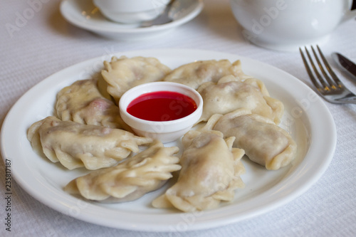 dumplings on a white background with red topping