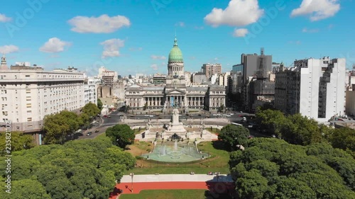 Aerial drone view of Buenos Aires national congress parliament building with dome roof, fountain plaza park and statute