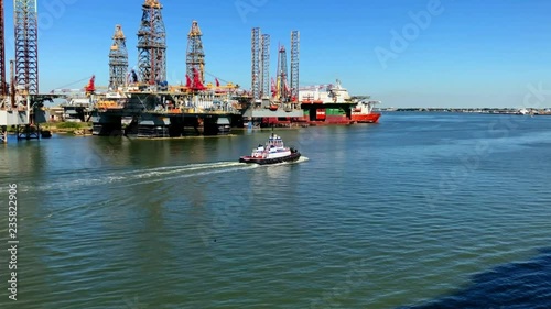 A Tug Boat moves up the Galveston Ship Channel in Slow Motion photo