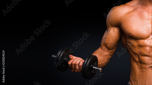 cropped image of male body, shirtless, portrait training with dumb-bell