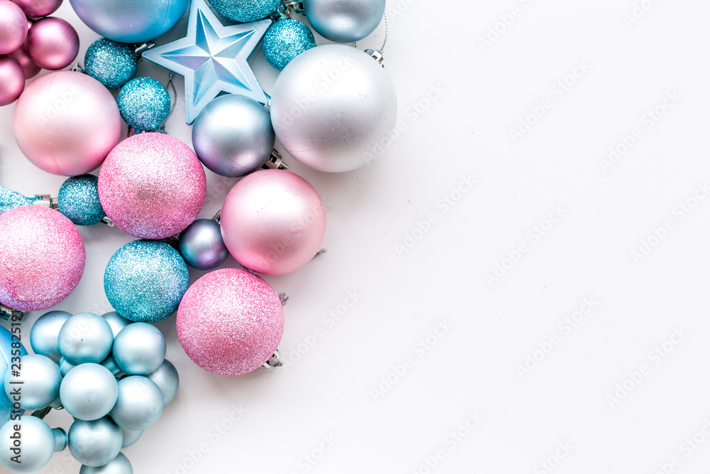 Christmas and New Year symbols. Toys for festive tree. Blue and pink balls and stars on white background top view copy space border Christmas and New Year symbols. Toys for festive tree. Blue and pink balls and stars on white background top view copy space border