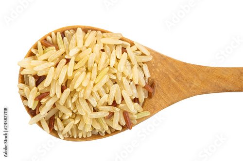 Brown rice on wooden spoon isolated on white background with clipping path