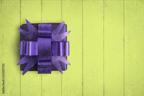 Purple box on yellow wood taable. © ParinPIX