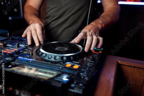 Dj playing disco house progressive electro music at the concert. DJ hands on equipment