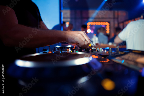 DJ entertaining a crowd in a party tent.