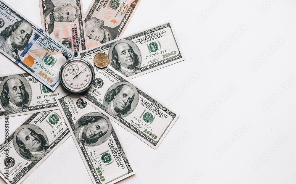 Stopwatch and dollars. Banknotes lie in the shape of a circle around the clock. Time is money concept. Money loan. Credit debt, copy space. Stopwatch and dollars. Banknotes lie in the shape of a circle around the clock. Time is money concept. Money loan. Credit debt, copy space.