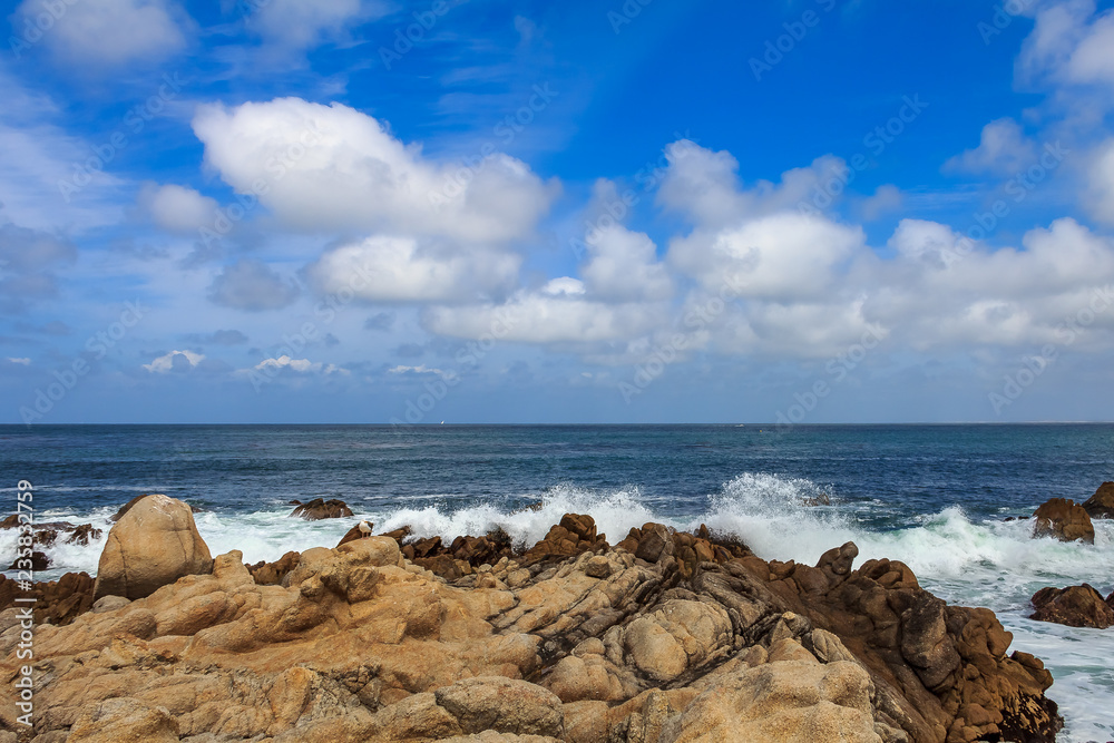 Pacific Ocean waves crashing on the rugged Northern California coastline in  Monterey