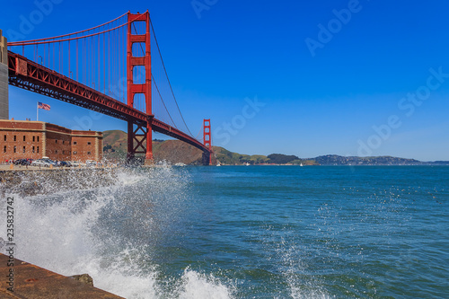 Waves crashing by the iconic Golden Gate Bridge in San Francisco, CA photo